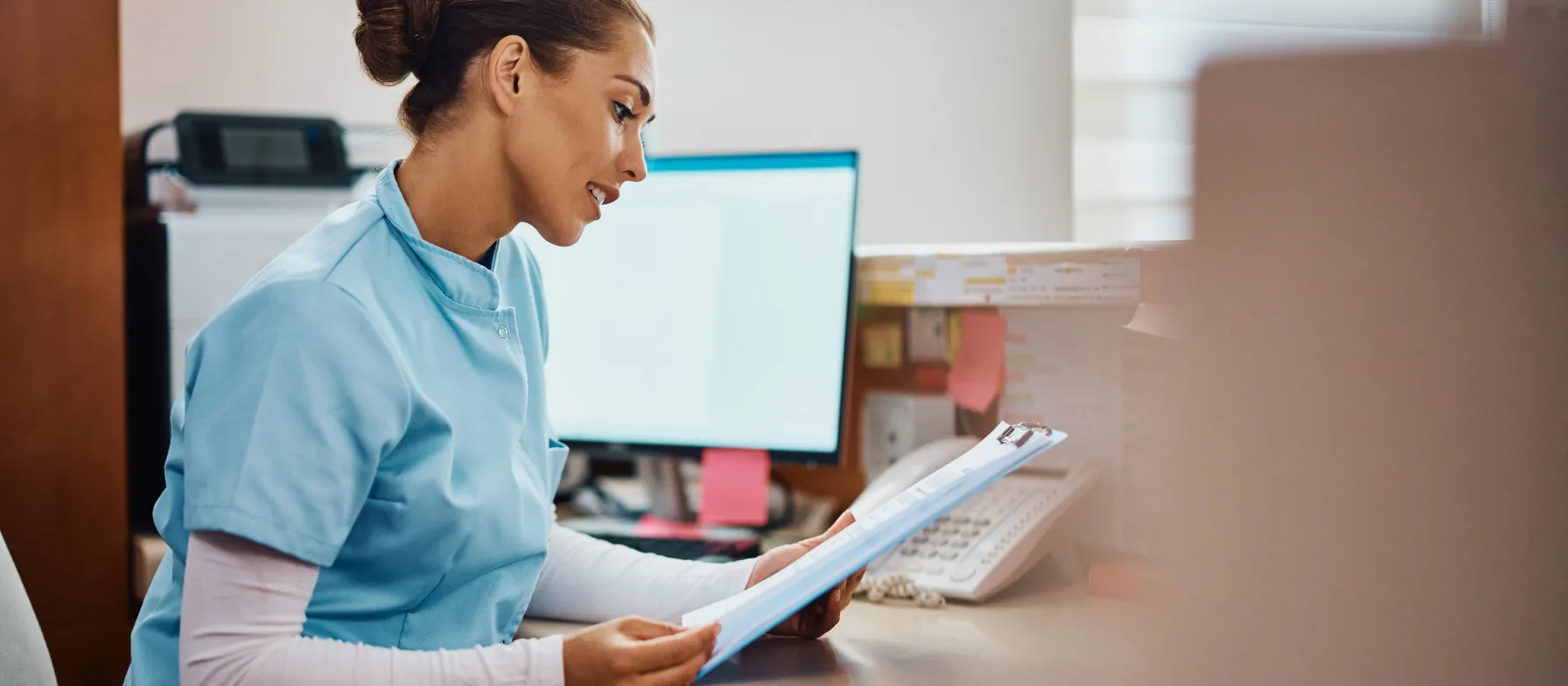 Nurse looking at paperwork 